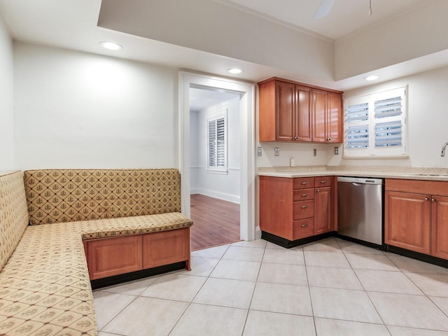 4521 W Azeele St, Tampa, FL 33609 - kitchen with dishwasher, recessed lighting, light tile patterned floors, brown cabinets, and a sink