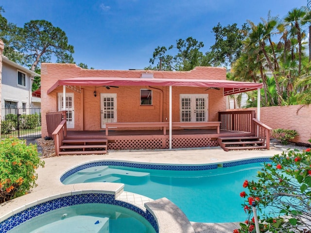 4521 W Azeele St, Tampa, FL 33609 - view of pool featuring a wooden deck, a pool with connected hot tub, and french doors