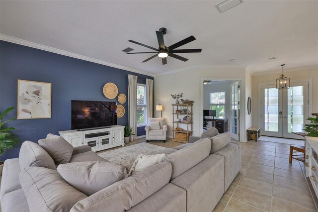 6468 Rubia Cir, Apollo Beach, FL 33572 - living room with a ceiling fan, french doors, healthy amount of natural light, ornamental molding, and light tile patterned floors