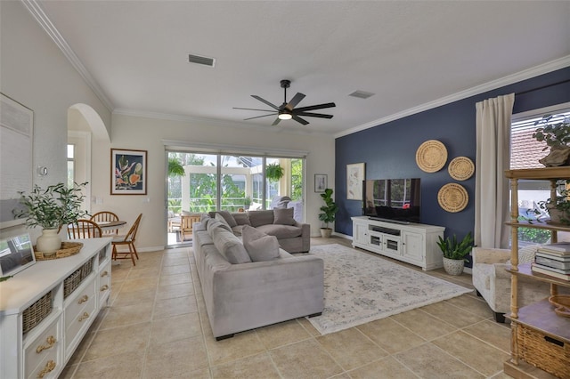 6468 Rubia Cir, Apollo Beach, FL 33572 - living room with a ceiling fan, ornamental molding, light tile patterned floors, arched walkways, and baseboards