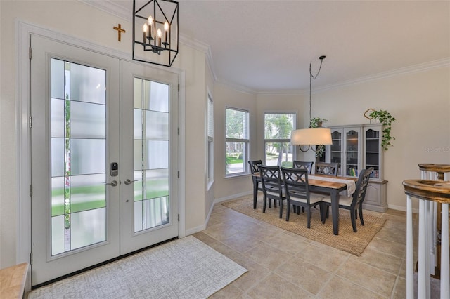 6468 Rubia Cir, Apollo Beach, FL 33572 - dining space with a chandelier, french doors, ornamental molding, light tile patterned flooring, and baseboards
