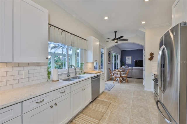 6468 Rubia Cir, Apollo Beach, FL 33572 - kitchen with stainless steel appliances, a sink, crown molding, recessed lighting, and white cabinetry