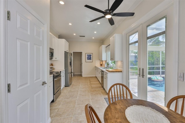 6468 Rubia Cir, Apollo Beach, FL 33572 - kitchen featuring appliances with stainless steel finishes, a sink, tasteful backsplash, crown molding, and recessed lighting