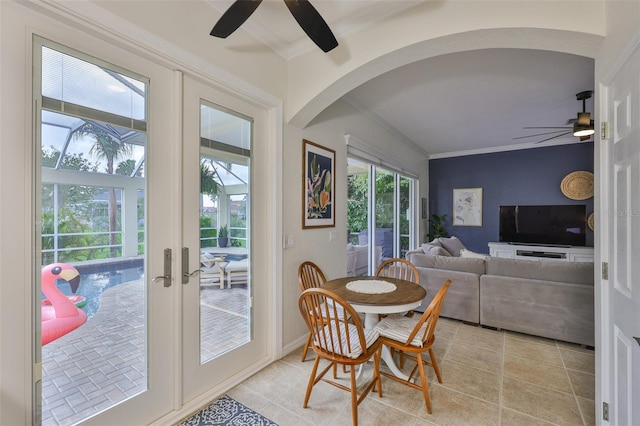 6468 Rubia Cir, Apollo Beach, FL 33572 - dining space with a ceiling fan, light tile patterned floors, ornamental molding, arched walkways, and french doors