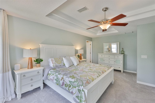 6468 Rubia Cir, Apollo Beach, FL 33572 - bedroom with light carpet, a tray ceiling, baseboards, and a ceiling fan