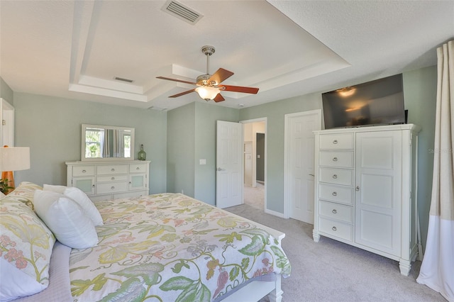 6468 Rubia Cir, Apollo Beach, FL 33572 - bedroom featuring a tray ceiling, light carpet, and a ceiling fan