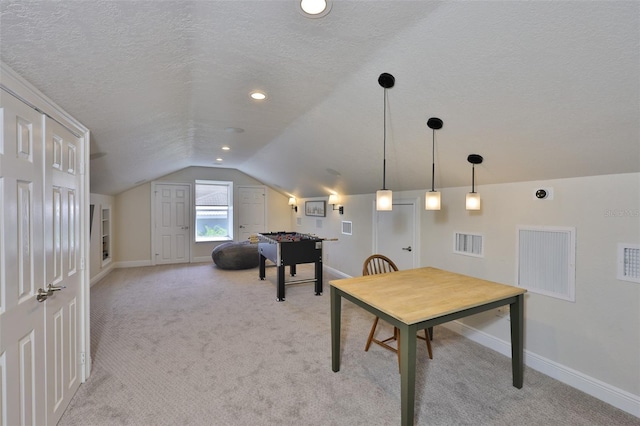 6468 Rubia Cir, Apollo Beach, FL 33572 - rec room with a textured ceiling, lofted ceiling, baseboards, and light colored carpet