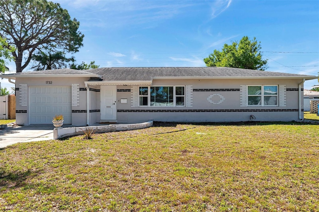 1732 63rd Ave N, Saint Petersburg, FL 33702 - ranch-style home featuring a garage, a front yard, stucco siding, driveway, and roof with shingles