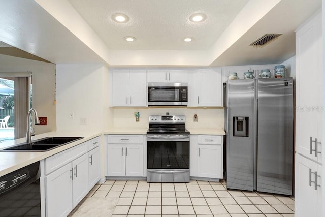 107 Halton Cir, Seffner, FL 33584 - kitchen with stainless steel appliances, a sink, white cabinetry, light countertops, and a textured ceiling