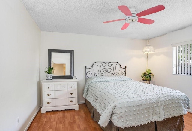 107 Halton Cir, Seffner, FL 33584 - bedroom with wood finished floors, a textured ceiling, baseboards, and a ceiling fan