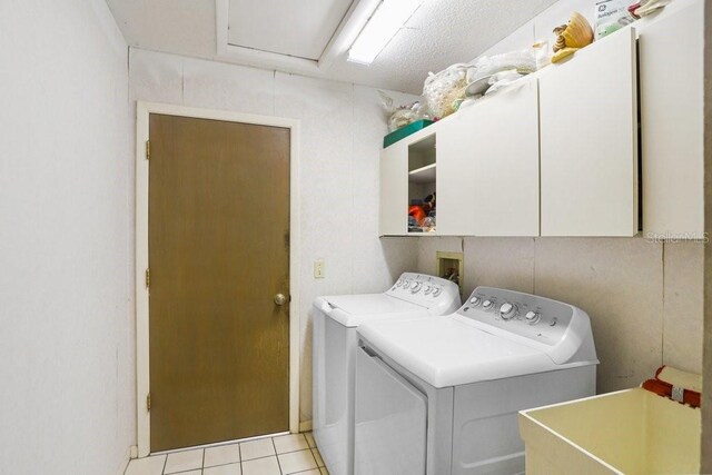 107 Halton Cir, Seffner, FL 33584 - laundry area with cabinet space, washer and clothes dryer, and light tile patterned floors