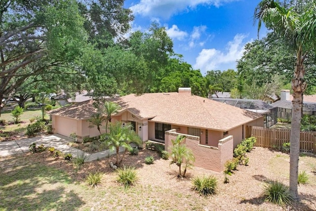 107 Halton Cir, Seffner, FL 33584 - view of front of property featuring a chimney, concrete driveway, a garage, and stucco siding