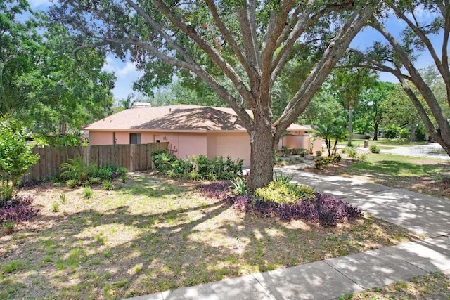 107 Halton Cir, Seffner, FL 33584 - view of front of property with a garage, a chimney, stucco siding, and concrete driveway