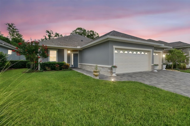 7991 Lake James Blvd, Lakeland, FL 33810 - ranch-style home with a garage, stucco siding, a front yard, and decorative driveway