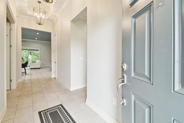 7991 Lake James Blvd, Lakeland, FL 33810 - foyer entrance with ornamental molding, a chandelier, baseboards, and light tile patterned floors