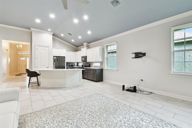 7991 Lake James Blvd, Lakeland, FL 33810 - kitchen featuring appliances with stainless steel finishes, crown molding, plenty of natural light, open floor plan, and light countertops