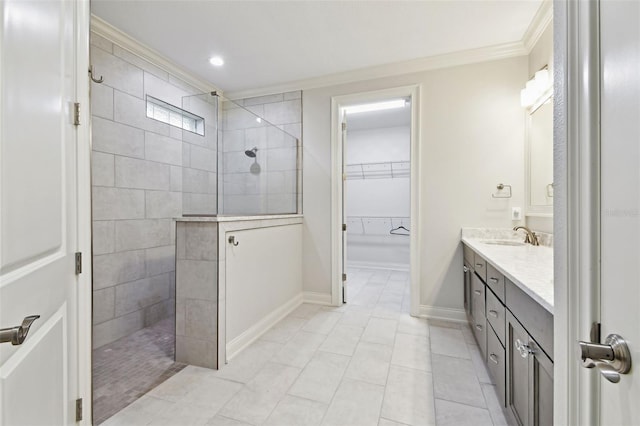 7991 Lake James Blvd, Lakeland, FL 33810 - bathroom featuring crown molding, walk in shower, vanity, a walk in closet, and baseboards