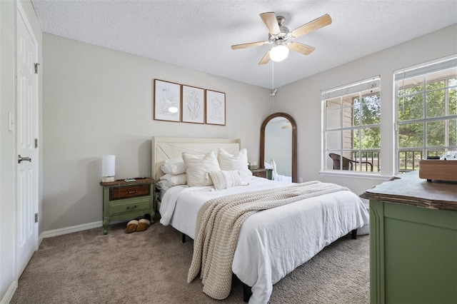 3301 Haviland Ct Unit 203, Palm Harbor, FL 34684 - bedroom with carpet floors, a textured ceiling, baseboards, and a ceiling fan