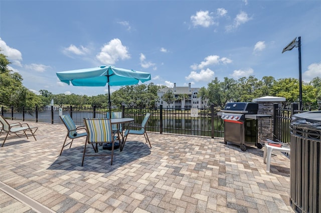 3301 Haviland Ct Unit 203, Palm Harbor, FL 34684 - view of patio with grilling area and a water view