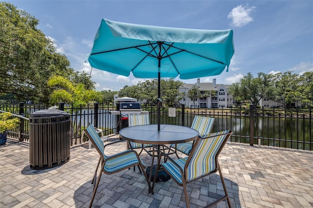 3301 Haviland Ct Unit 203, Palm Harbor, FL 34684 - view of patio / terrace featuring a water view and outdoor dining area