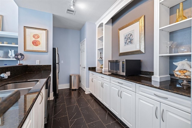 3301 Haviland Ct Unit 203, Palm Harbor, FL 34684 - kitchen with open shelves, appliances with stainless steel finishes, and dark stone countertops