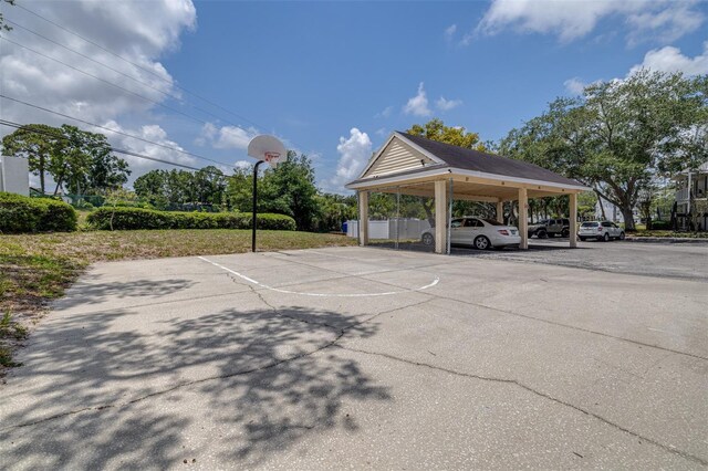 3301 Haviland Ct Unit 203, Palm Harbor, FL 34684 - partially covered parking lot featuring community basketball court