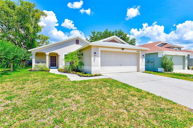 22943 Sills Loop, Land O Lakes, FL 34639 - single story home with an attached garage, stucco siding, concrete driveway, and a front yard