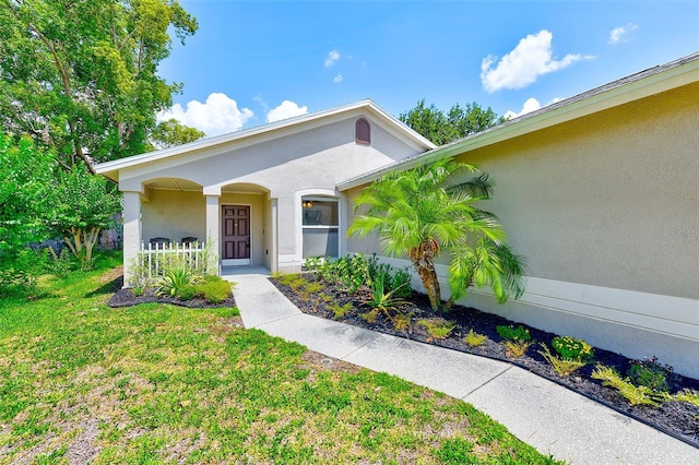 22943 Sills Loop, Land O Lakes, FL 34639 - view of front facade with stucco siding and a front yard