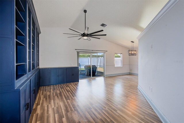 22943 Sills Loop, Land O Lakes, FL 34639 - unfurnished room with lofted ceiling, a chandelier, ceiling fan, and wood finished floors