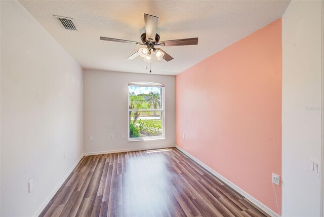 22943 Sills Loop, Land O Lakes, FL 34639 - spare room with wood finished floors, ceiling fan, baseboards, and a textured ceiling