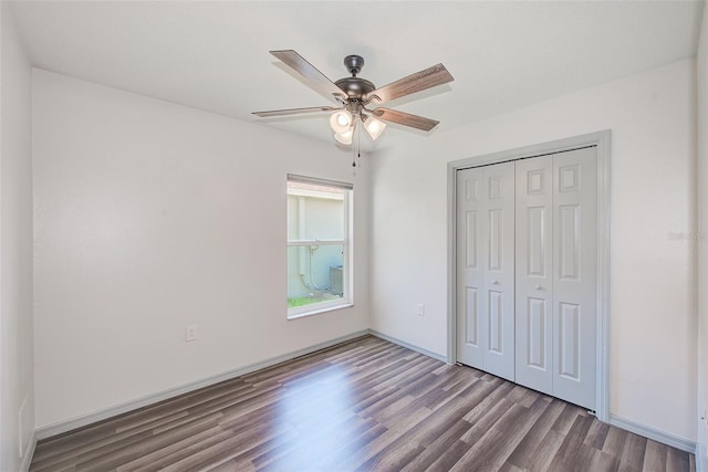 22943 Sills Loop, Land O Lakes, FL 34639 - unfurnished bedroom with wood finished floors, a closet, a ceiling fan, and baseboards