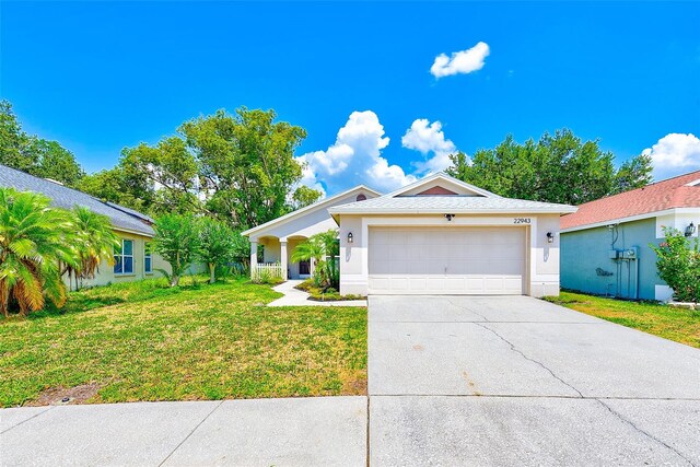 22943 Sills Loop, Land O Lakes, FL 34639 - single story home with driveway, a front lawn, a garage, and stucco siding