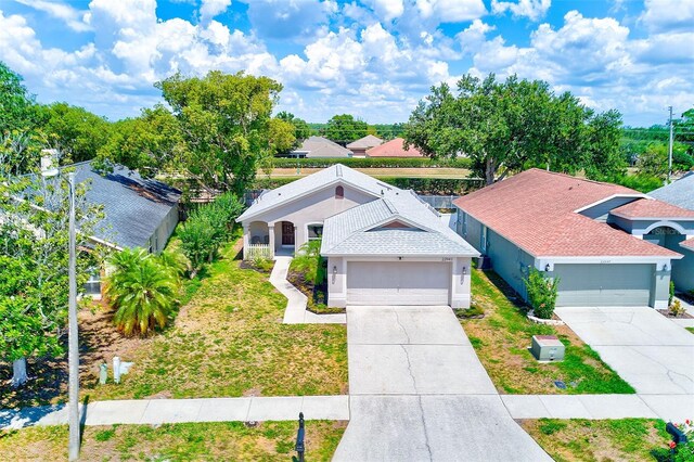 22943 Sills Loop, Land O Lakes, FL 34639 - view of front of property featuring concrete driveway, a front lawn, and stucco siding