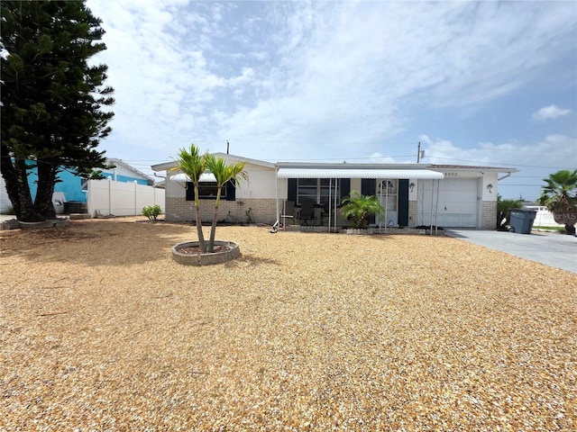 4902 Panorama Ave, Holiday, FL 34690 - manufactured / mobile home with brick siding, a garage, and concrete driveway
