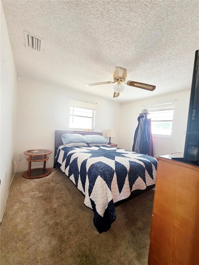 4902 Panorama Ave, Holiday, FL 34690 - carpeted bedroom with ceiling fan and a textured ceiling