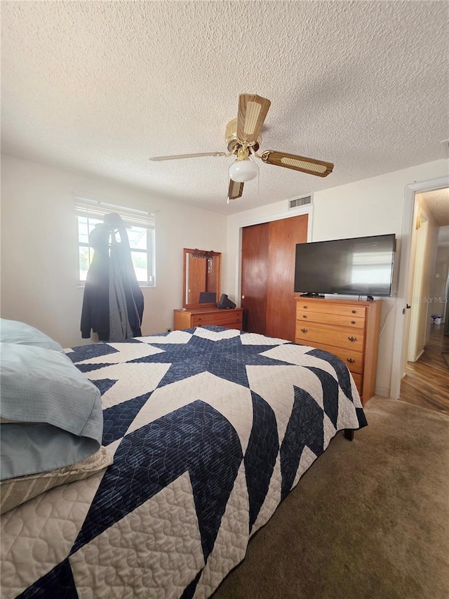 4902 Panorama Ave, Holiday, FL 34690 - bedroom featuring a closet, ceiling fan, a textured ceiling, and light carpet