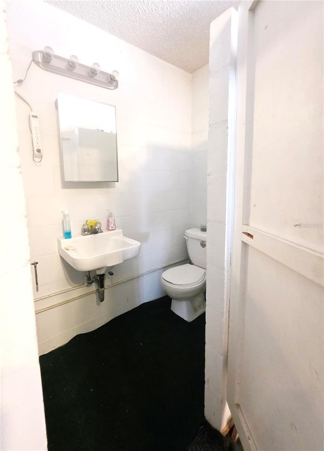4902 Panorama Ave, Holiday, FL 34690 - bathroom with a sink, a textured ceiling, and toilet