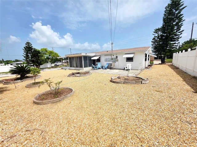 4902 Panorama Ave, Holiday, FL 34690 - rear view of property with a sunroom, a patio, and stucco siding