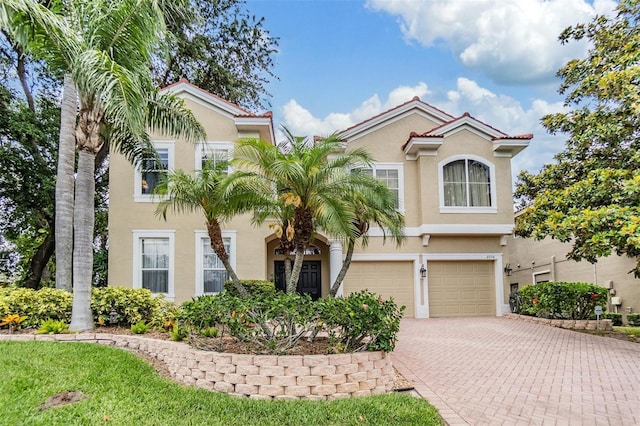 2354 Messenger Cir, Safety Harbor, FL 34695 - view of front of house featuring stucco siding, decorative driveway, and a garage