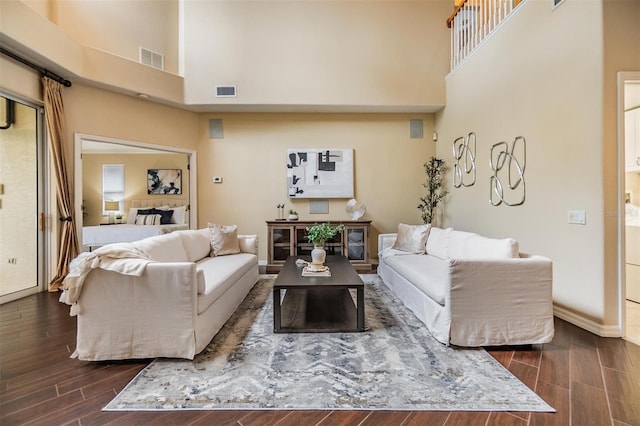 2354 Messenger Cir, Safety Harbor, FL 34695 - living room featuring a towering ceiling, dark wood-style flooring, and baseboards