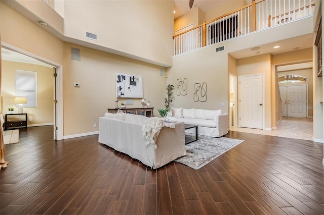 2354 Messenger Cir, Safety Harbor, FL 34695 - living area featuring a towering ceiling, dark wood-type flooring, and baseboards