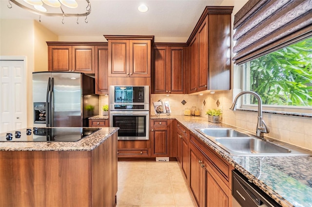 2354 Messenger Cir, Safety Harbor, FL 34695 - kitchen featuring stainless steel appliances, a sink, tasteful backsplash, light tile patterned floors, and light stone countertops