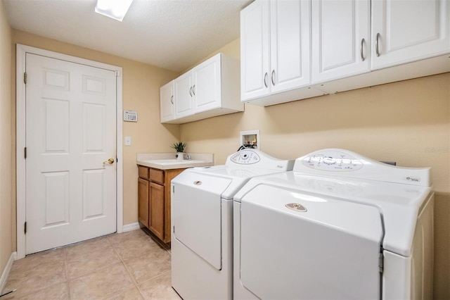 2354 Messenger Cir, Safety Harbor, FL 34695 - laundry area featuring independent washer and dryer, cabinet space, baseboards, and light tile patterned floors