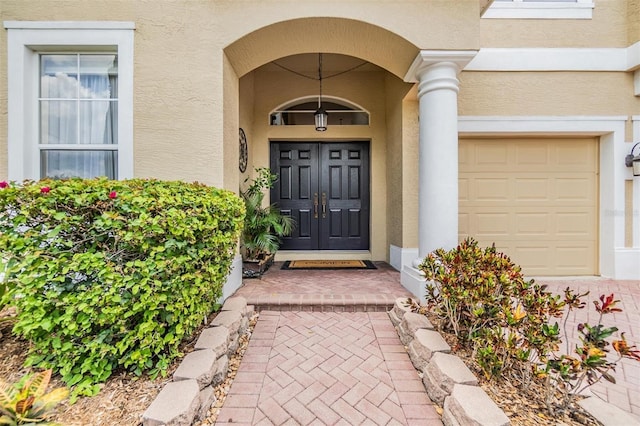 2354 Messenger Cir, Safety Harbor, FL 34695 - view of exterior entry featuring stucco siding and an attached garage