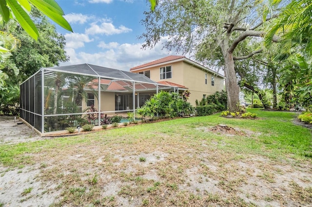 2354 Messenger Cir, Safety Harbor, FL 34695 - back of house with stucco siding, a yard, and a lanai