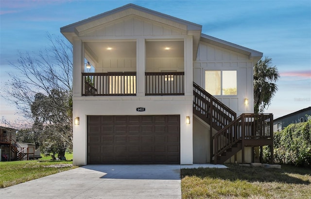 6433 Werner Ave, New Port Richey, FL 34652 - view of front facade featuring board and batten siding, a garage, stairway, and concrete driveway