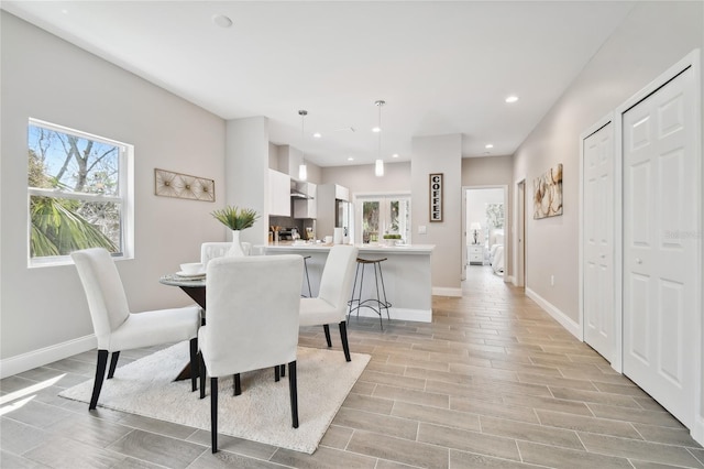 6433 Werner Ave, New Port Richey, FL 34652 - dining room with plenty of natural light, baseboards, wood tiled floors, and recessed lighting
