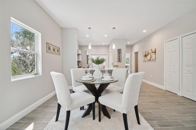 6433 Werner Ave, New Port Richey, FL 34652 - dining area featuring baseboards, wood finish floors, and recessed lighting