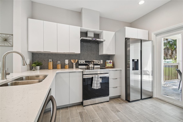 6433 Werner Ave, New Port Richey, FL 34652 - kitchen with stainless steel appliances, wall chimney range hood, a sink, backsplash, and recessed lighting