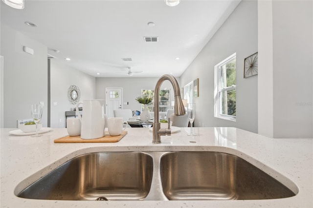 6433 Werner Ave, New Port Richey, FL 34652 - kitchen view of a sink, light stone countertops, ceiling fan, and recessed lighting